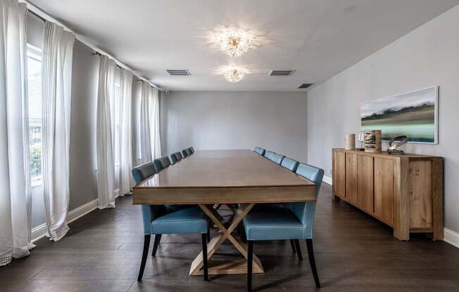 A dining room with a wooden table and blue chairs