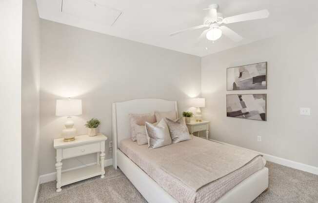 a bedroom with a bed and a ceiling fan at Highlands Apartment Homes, Bartlett, TN, 38135