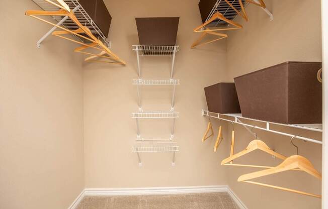 A walk-in closet with shelves and hangers.