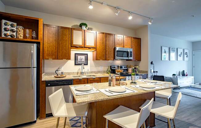 A modern kitchen with a dining table set for four.