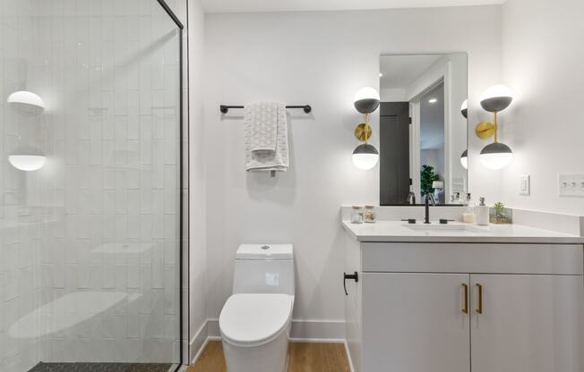 a white bathroom with a shower and a sink and a toilet at Rialto, Washington, DC 20002