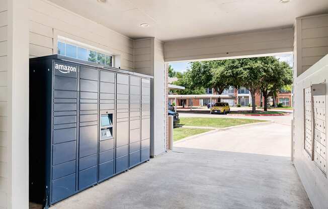 the lockers at the end of the driveway of an apartment building