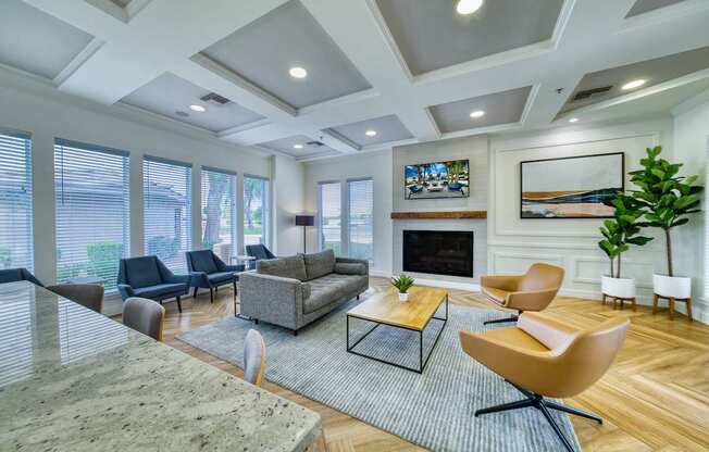 A living room with a fireplace and a painting above it.
