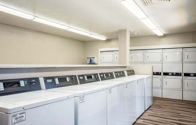 A row of washing machines in a laundromat.