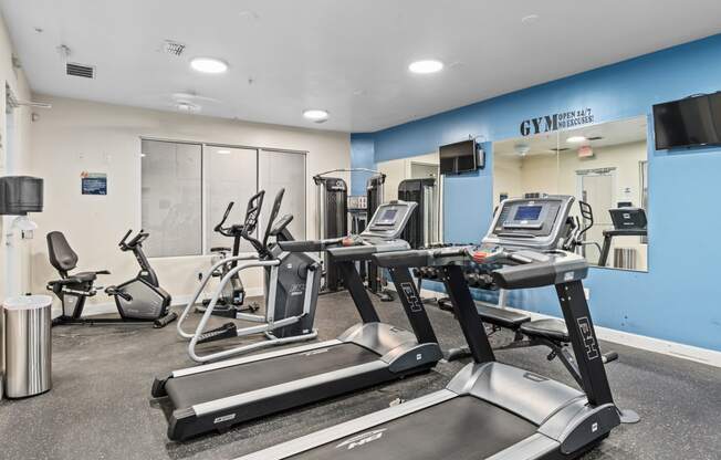 a gym with treadmills and other exercise equipment in a building