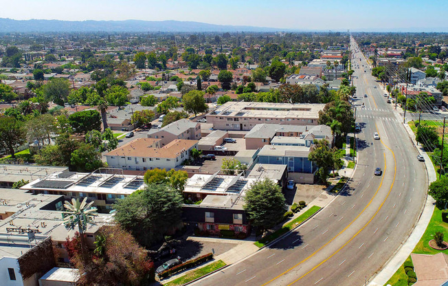 Aerial drone photo of 10620 NoHo showing solar panels and energy-efficient white roofing.