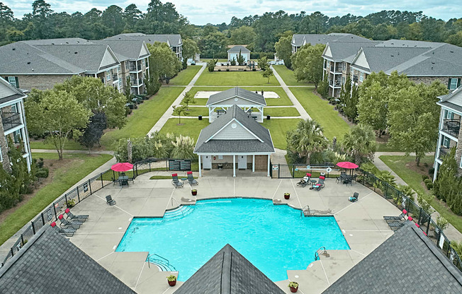 A large swimming pool surrounded by apartment buildings.