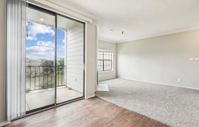 A2 floor plan dining and living room with sliding glass doors to a balcony at Jefferson Creek Apartments in Irving, TX.