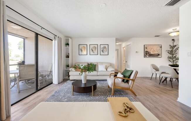 a living room with a white couch and a sliding glass door