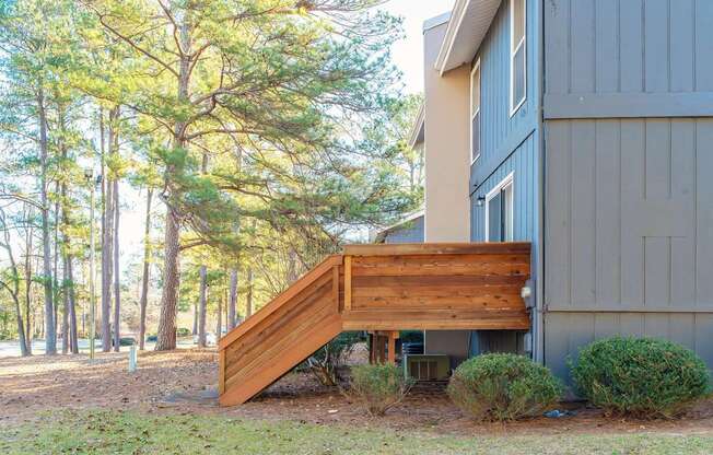 A wooden staircase leads up to a house.