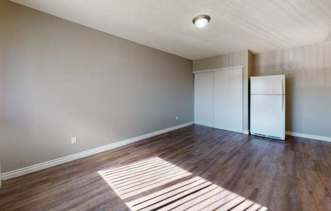 Apartments for Rent in Colton - Las Brisas One Bedroom Apartment Living Room with Hardwood Flooring and Large Window