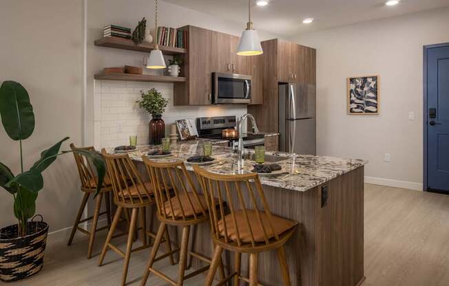 A kitchen with a table and chairs.