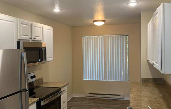 Kitchen with a Sink and Refrigerator at Arcadia Townhomes, Federal Way, WA, 98023