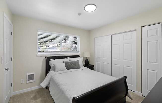 Spacious Bedroom with Large Closet, Plush Carpeting, and Overhead Lighting at Pinewood Square Apartment Homes, Washington