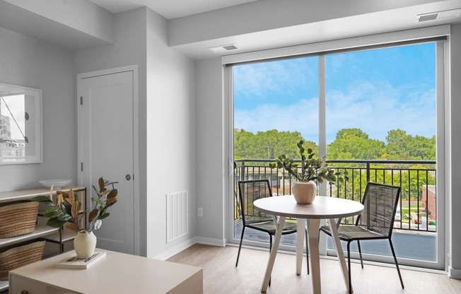 a seating area with a table and chairs in a 555 waverly unit
