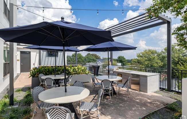 a patio with tables and umbrellas on a roof