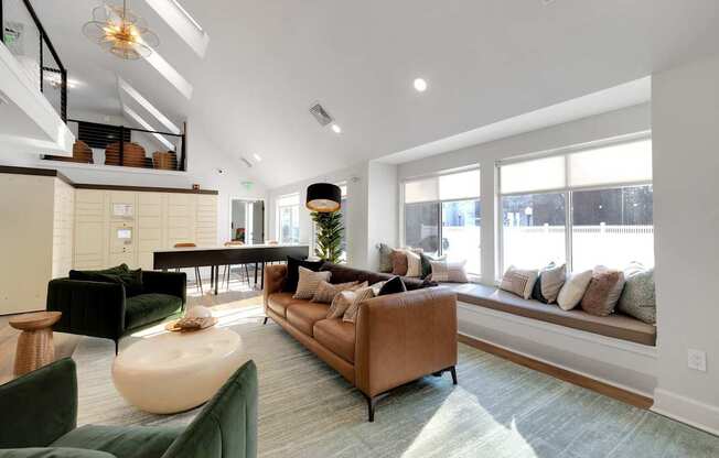 A living room with a brown sofa and a green armchair.