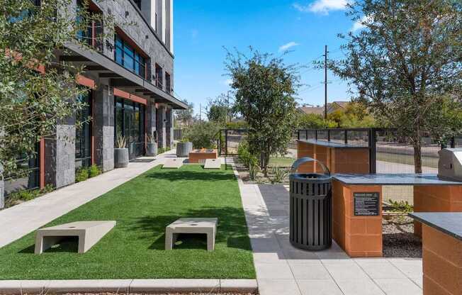A modern building with a green lawn in front.