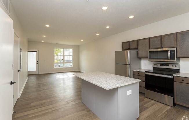 A kitchen with a white countertop and stainless steel appliances.