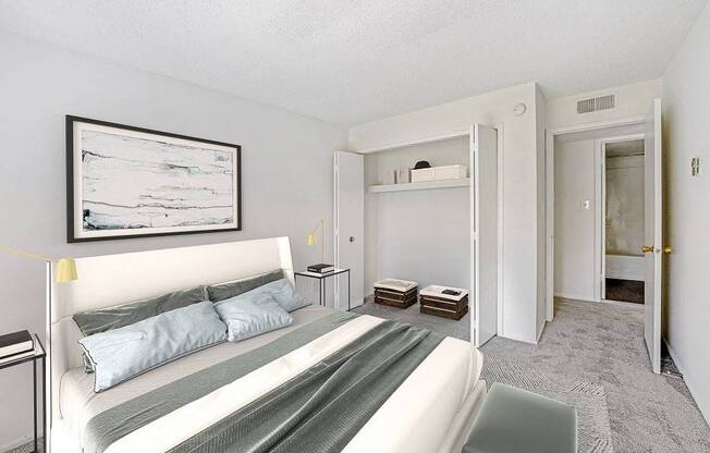 A bedroom with a bed, nightstands, and a painting on the wall.