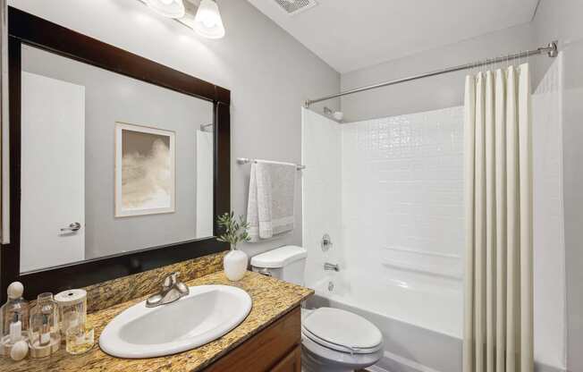 a bathroom with a white shower and a sink and a mirror
