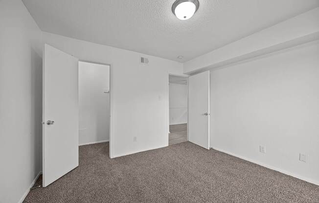 A room with carpeted floor and white walls.