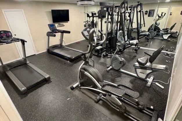A well equipped gym with treadmills, weights and exercise machines.