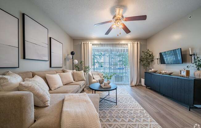 a living room with a couch and a ceiling fan