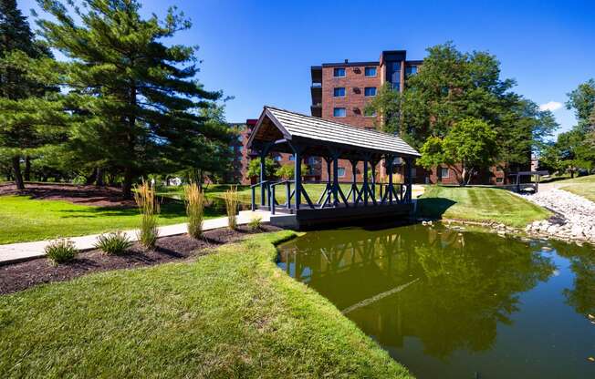 The Bennington Apartments property with a covered bridge over a small body of water