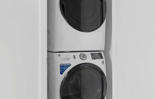 a white washer and dryer in a small laundry room