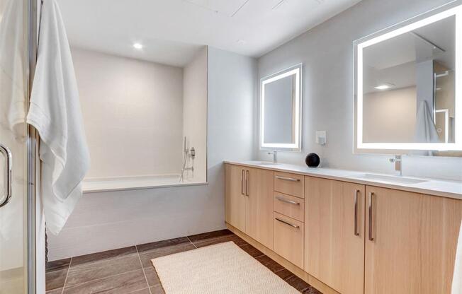 a bathroom with a shower and a sink and a mirror