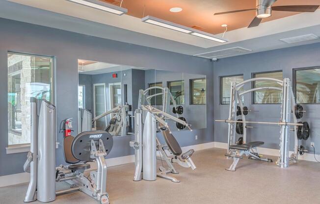 A gym with a variety of exercise equipment.