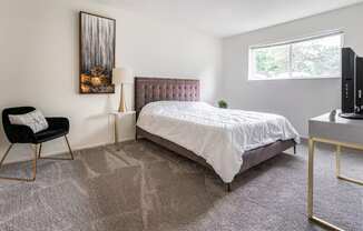 an apartment bedroom with a bed and a window