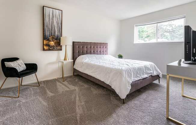 an apartment bedroom with a bed and a window