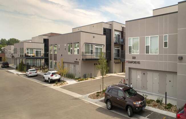 a view of a building with cars parked in front of it