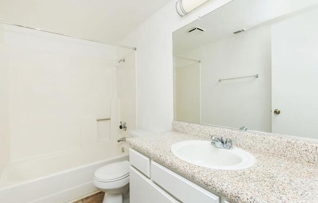 a large white tub next to a sink