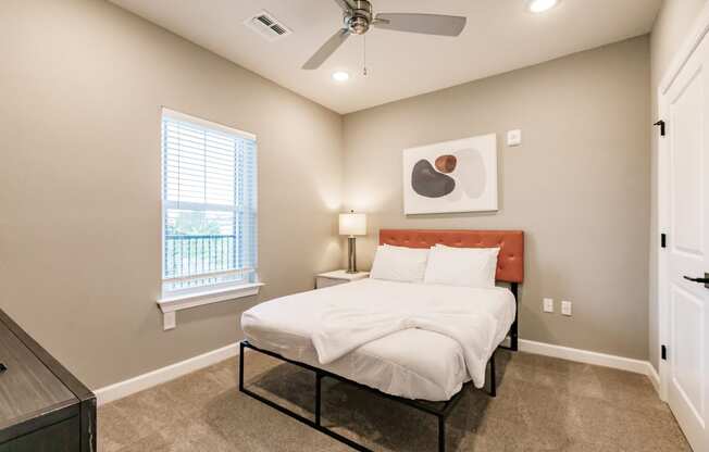 a bedroom with a bed and night stand at Vantage Luxury Apartments in Cape Coral, FL