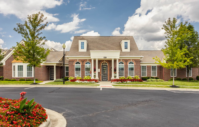 a large brick house with a driveway in front of it