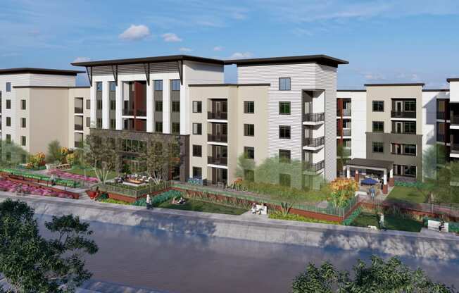 an aerial view of an apartment complex with a pond