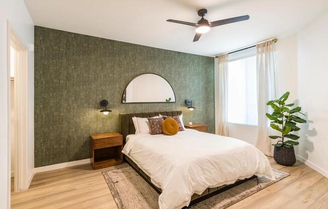 Inviting and refined, bedrooms at Modera Higley Commons pair natural textures with soft light for an effortlessly elevated feel.
