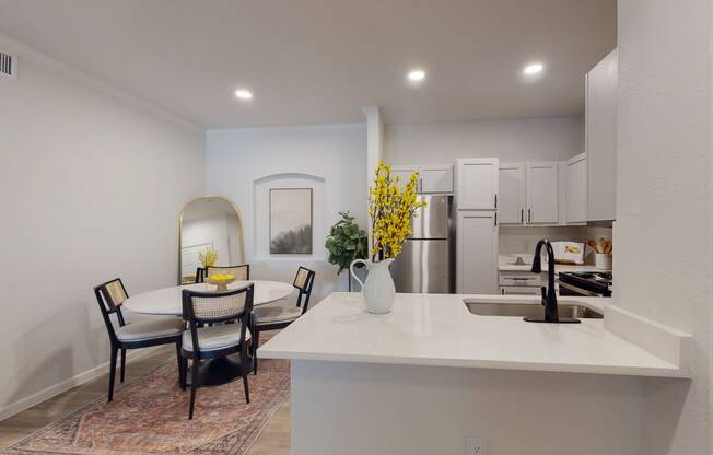 a kitchen and dining area with a table and chairs