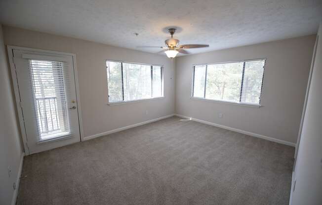 Carpeted bedroom with a ceiling fan at Wynnwood Vinings Atlanta