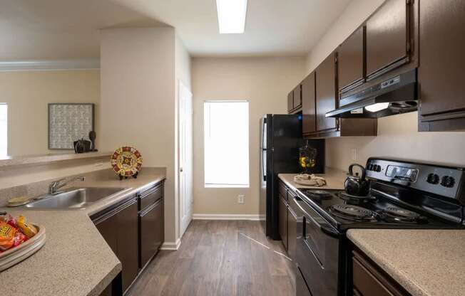 a kitchen with stainless steel appliances and granite counter tops
