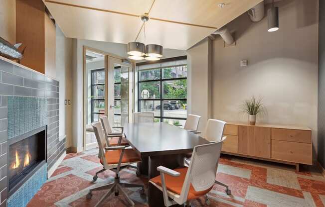 a room with a table and chairs and a fireplace