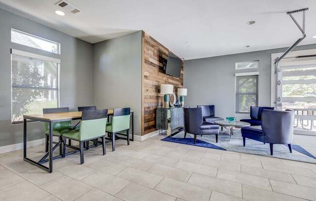 A modern living room with a dining table and chairs.