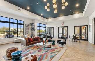 a living room with couches and chairs and a chandelier