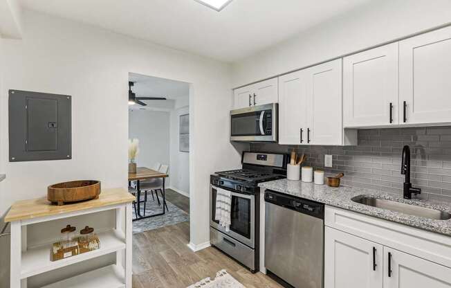 Modern kitchen with stainless steel appliances and white cabinets at Columbia Pointe, Columbia, Maryland 