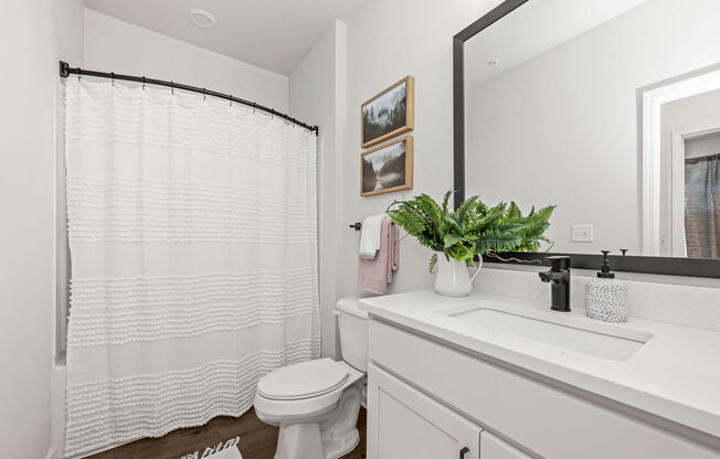 a bathroom with a white sink and a toilet