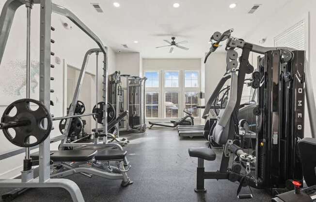 A well-equipped gym with a variety of machines and weights.