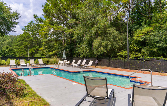 Pool & Sundeck Surrounded By Lush Trees & Landscaping